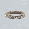 14K yellow gold eternity ring encircled in CZs; also in white gold